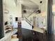 Bright, open-concept living space with high ceilings, dark wood floors, and a view of the staircase at 2429 Worchester Rd, Henderson, NV 89074