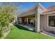 Backyard showcases artificial turf and covered patio seating area for entertaining at 2505 Palmridge Dr, Las Vegas, NV 89134