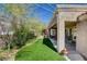 Backyard showcases artificial turf and covered patio seating area for entertaining at 2505 Palmridge Dr, Las Vegas, NV 89134