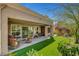 Backyard features covered patio seating area and a lush landscaped yard at 2505 Palmridge Dr, Las Vegas, NV 89134
