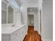 Bright bathroom featuring a white vanity, decorative mirror, and stylish wood flooring at 2505 Palmridge Dr, Las Vegas, NV 89134