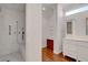 Bathroom with walk-in shower with updated fixtures, vanity, and wood floors at 2505 Palmridge Dr, Las Vegas, NV 89134