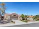 Inviting single-story home with a well-maintained yard, red tile roof and two-car garage at 2505 Palmridge Dr, Las Vegas, NV 89134