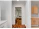 Hallway featuring pristine wood floors leading to custom closets with built-in shelves at 2505 Palmridge Dr, Las Vegas, NV 89134