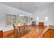 Well-lit living room with plantation shutters, hardwood floors, and a classic dining set at 2505 Palmridge Dr, Las Vegas, NV 89134