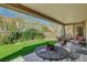 Inviting covered patio featuring stylish outdoor furniture and a well-manicured lawn at 2505 Palmridge Dr, Las Vegas, NV 89134