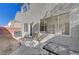 A home's backyard features a concrete patio, stucco walls, and nearby air conditioning unit at 2612 Kindness Ct, North Las Vegas, NV 89031