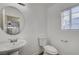 Bathroom with wood floor and pedestal sink with a view of the hallway at 2612 Kindness Ct, North Las Vegas, NV 89031