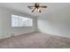Neutral bedroom featuring carpet floors, a ceiling fan, and a window providing natural light at 2612 Kindness Ct, North Las Vegas, NV 89031