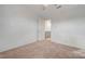 A bedroom featuring a walk-in closet and neutral carpet, with a door leading to an adjoining bathroom at 2612 Kindness Ct, North Las Vegas, NV 89031