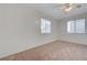 Bedroom with neutral carpet, ceiling fan, and natural light from two windows at 2612 Kindness Ct, North Las Vegas, NV 89031