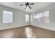 Bedroom features wood-look tile floors and natural light from two large windows at 2612 Kindness Ct, North Las Vegas, NV 89031