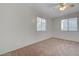 Bedroom with neutral carpet, ceiling fan, and natural light from two windows at 2612 Kindness Ct, North Las Vegas, NV 89031