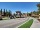 Luxury gated community entrance with lush landscaping and paved roads at 2612 Kindness Ct, North Las Vegas, NV 89031