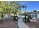 Community pool area with mature landscaping, secure fencing, and shade trees creating a resort-style atmosphere at 2612 Kindness Ct, North Las Vegas, NV 89031