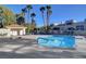 Outdoor community pool with tiled roof and lounge chairs, creating a relaxing oasis for residents at 2612 Kindness Ct, North Las Vegas, NV 89031
