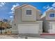 An exterior view of a two-story home with a two car garage at 2612 Kindness Ct, North Las Vegas, NV 89031