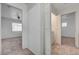 Hallway with neutral carpet, and view to bedroom and laundry room at 2612 Kindness Ct, North Las Vegas, NV 89031