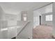 Hallway featuring neutral carpet, a railing, and a view of the bedroom at 2612 Kindness Ct, North Las Vegas, NV 89031