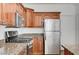 Well-equipped kitchen with stainless steel appliances, granite countertops, and beautiful wood cabinetry at 2612 Kindness Ct, North Las Vegas, NV 89031