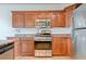 Modern kitchen features stainless steel appliances and granite countertops with updated cabinets at 2612 Kindness Ct, North Las Vegas, NV 89031