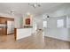 Open-concept living room featuring tile floors and a view into the updated kitchen at 2612 Kindness Ct, North Las Vegas, NV 89031
