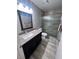 Bathroom featuring a granite countertop vanity and a glass door shower at 3324 Haven Beach Way, Las Vegas, NV 89117