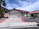 Charming single-story home featuring a red tile roof, desert landscaping, and an attached two-car garage at 3324 Haven Beach Way, Las Vegas, NV 89117