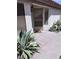 This front entrance features desert landscaping and a screen door, providing curb appeal and functionality at 3324 Haven Beach Way, Las Vegas, NV 89117