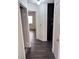 Hallway leading to a bedroom featuring dark wood floors and a storage cabinet at 3324 Haven Beach Way, Las Vegas, NV 89117