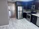 Stylish kitchen featuring stainless steel appliances, granite countertops, and dark wood cabinets at 3324 Haven Beach Way, Las Vegas, NV 89117