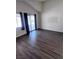 Bright living room featuring wood floors, a sliding glass door, and high ceilings at 3324 Haven Beach Way, Las Vegas, NV 89117