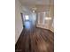 Spacious living room featuring wood flooring, vaulted ceilings, and abundant natural light from large windows at 3324 Haven Beach Way, Las Vegas, NV 89117