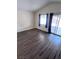 Bright living room featuring wood floors, a sliding glass door and window at 3324 Haven Beach Way, Las Vegas, NV 89117