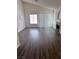 Bright living room featuring wood floors, a fireplace, and large windows that provide ample natural light at 3324 Haven Beach Way, Las Vegas, NV 89117