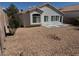 The backyard has desert landscaping for low maintenance and a relaxing outdoor space at 3641 Spring Day Ct, Las Vegas, NV 89147