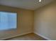 Bedroom featuring tiled floors, tan walls and a bright window at 3641 Spring Day Ct, Las Vegas, NV 89147