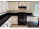 Modern kitchen featuring white cabinets and black appliances, including a gas range at 3641 Spring Day Ct, Las Vegas, NV 89147