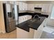 Bright kitchen featuring modern stainless steel appliances and black countertops at 3641 Spring Day Ct, Las Vegas, NV 89147