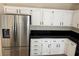 Kitchen with modern stainless steel refrigerator and white cabinets with black hardware at 3641 Spring Day Ct, Las Vegas, NV 89147