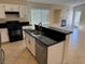 Modern kitchen island with stainless steel sink and view of the living area at 3641 Spring Day Ct, Las Vegas, NV 89147
