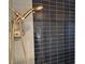 Shower with blue and black tiled walls, and modern fixtures at 3641 Spring Day Ct, Las Vegas, NV 89147