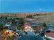 Wide aerial view of the property showcasing the home's landscaping and surrounding desert environment at 4061 W Eldorado Ln, Las Vegas, NV 89139