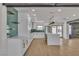 Modern kitchen features sleek white cabinets, green backsplash, and stainless steel appliances at 4061 W Eldorado Ln, Las Vegas, NV 89139