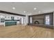 Spacious living room features a brick fireplace, open layout with kitchen, and ample natural light at 4061 W Eldorado Ln, Las Vegas, NV 89139