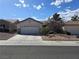 Charming single-story home with a two-car garage and low-maintenance desert landscaping in a sunny day at 415 Golden State St, Henderson, NV 89012