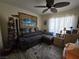 Comfortable living room with a ceiling fan, a gray sofa, and a coastal theme, offering a relaxed ambiance at 415 Golden State St, Henderson, NV 89012