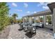Inviting outdoor living space with comfortable seating, a modern fire pit, and well-manicured landscaping at 4430 Angelo Rosa St, Las Vegas, NV 89135