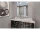 Modern bathroom features a unique vanity with gray textured walls and a sleek mirror at 4430 Angelo Rosa St, Las Vegas, NV 89135