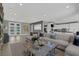 Open-concept living room with a large comfortable sofa and modern decor at 4430 Angelo Rosa St, Las Vegas, NV 89135